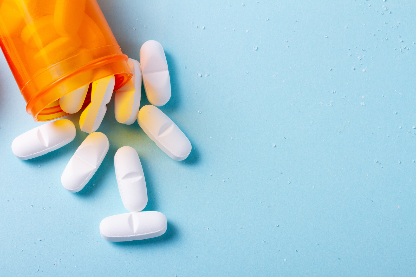 White pills on blue background